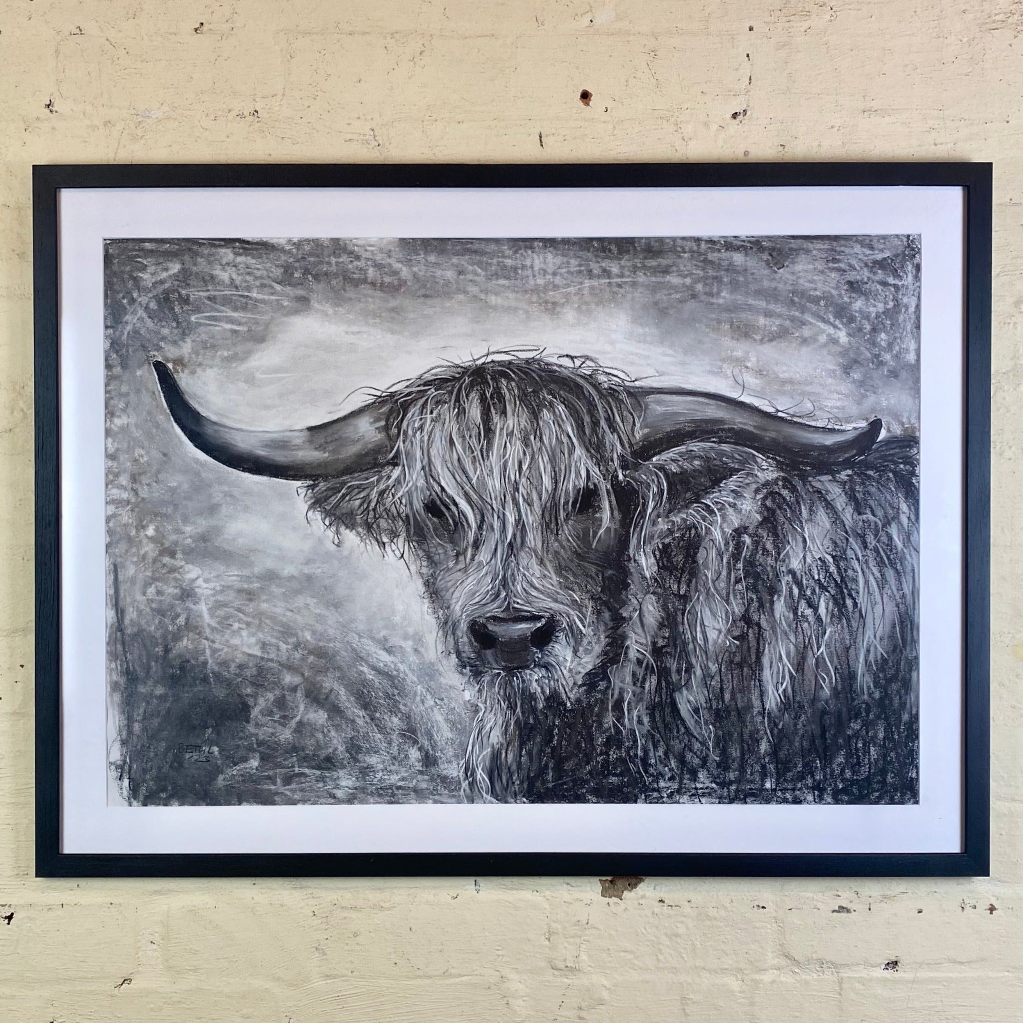 Black and white cow sketch in black frame
