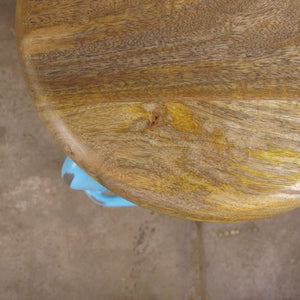 Close up of wooden top stool made from recycled materials. 