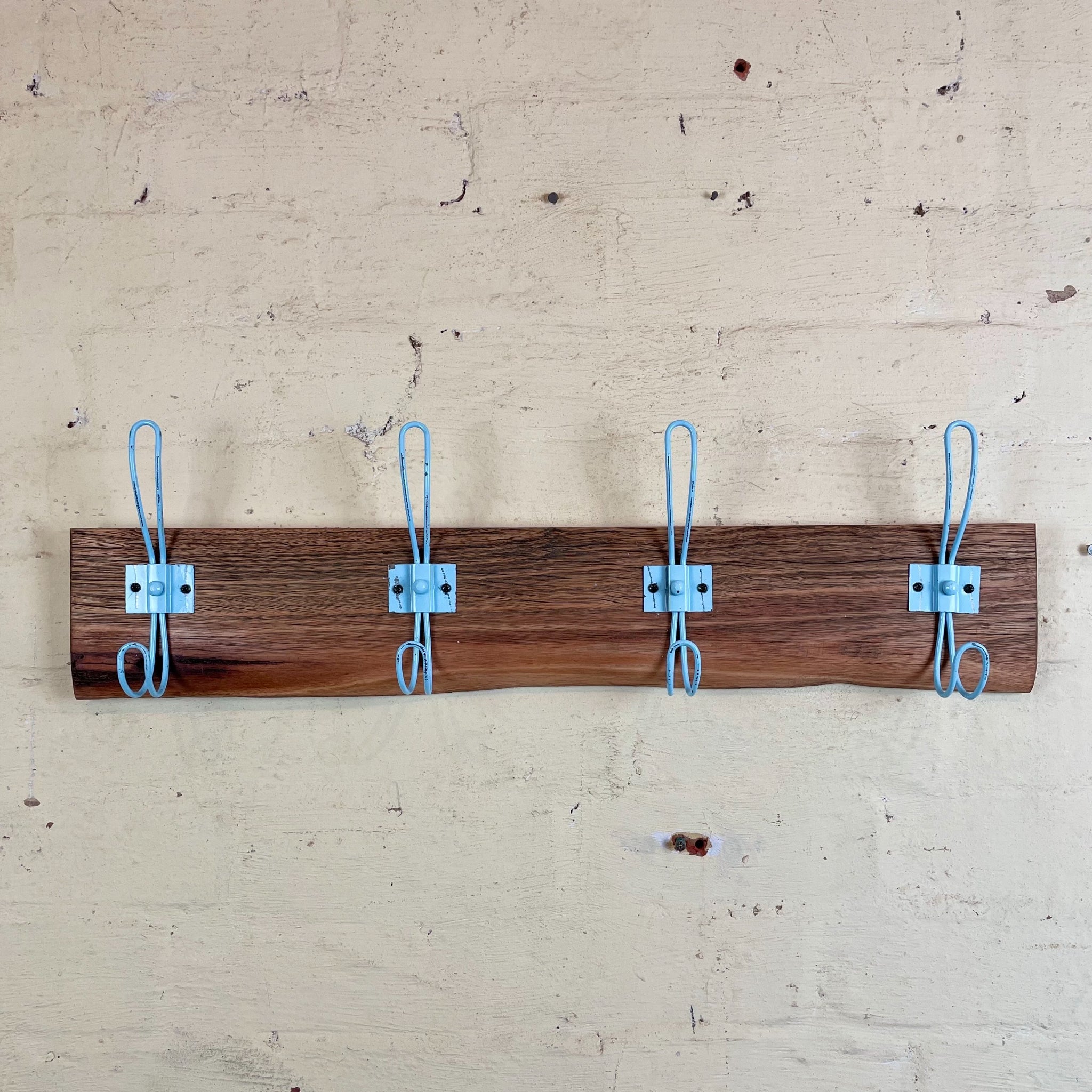Brown wooden coatrack with blue hooks, Australia. Hallway hat stand. 