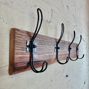 Wooden coat rack and hat rack with black hooks. Australia