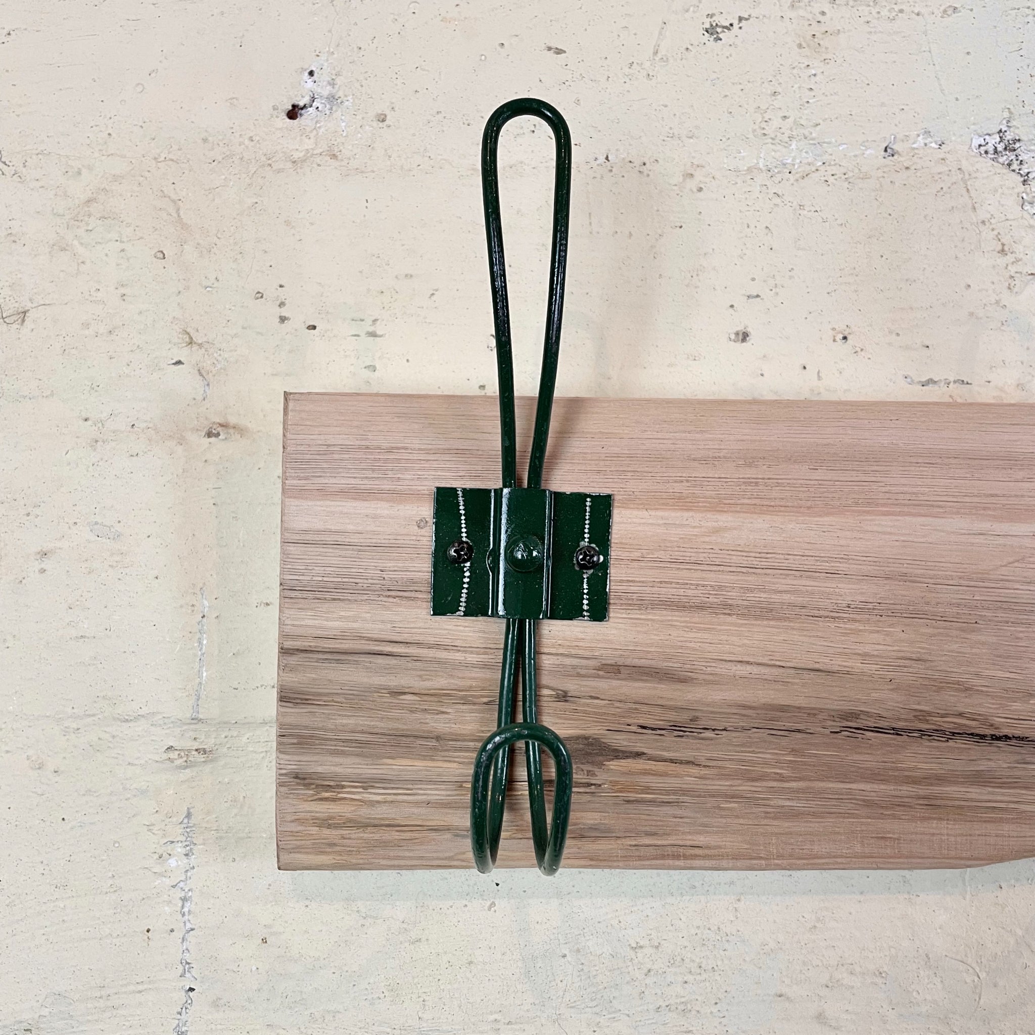 Recycled wooden coat rack with dark green hooks Australia.