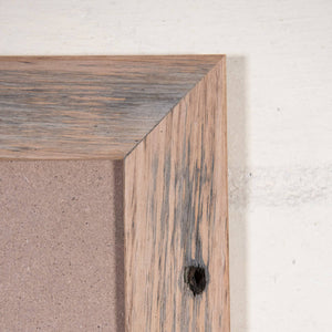 Close up of corner of natural portrait photo frame, made from recycled timber. 