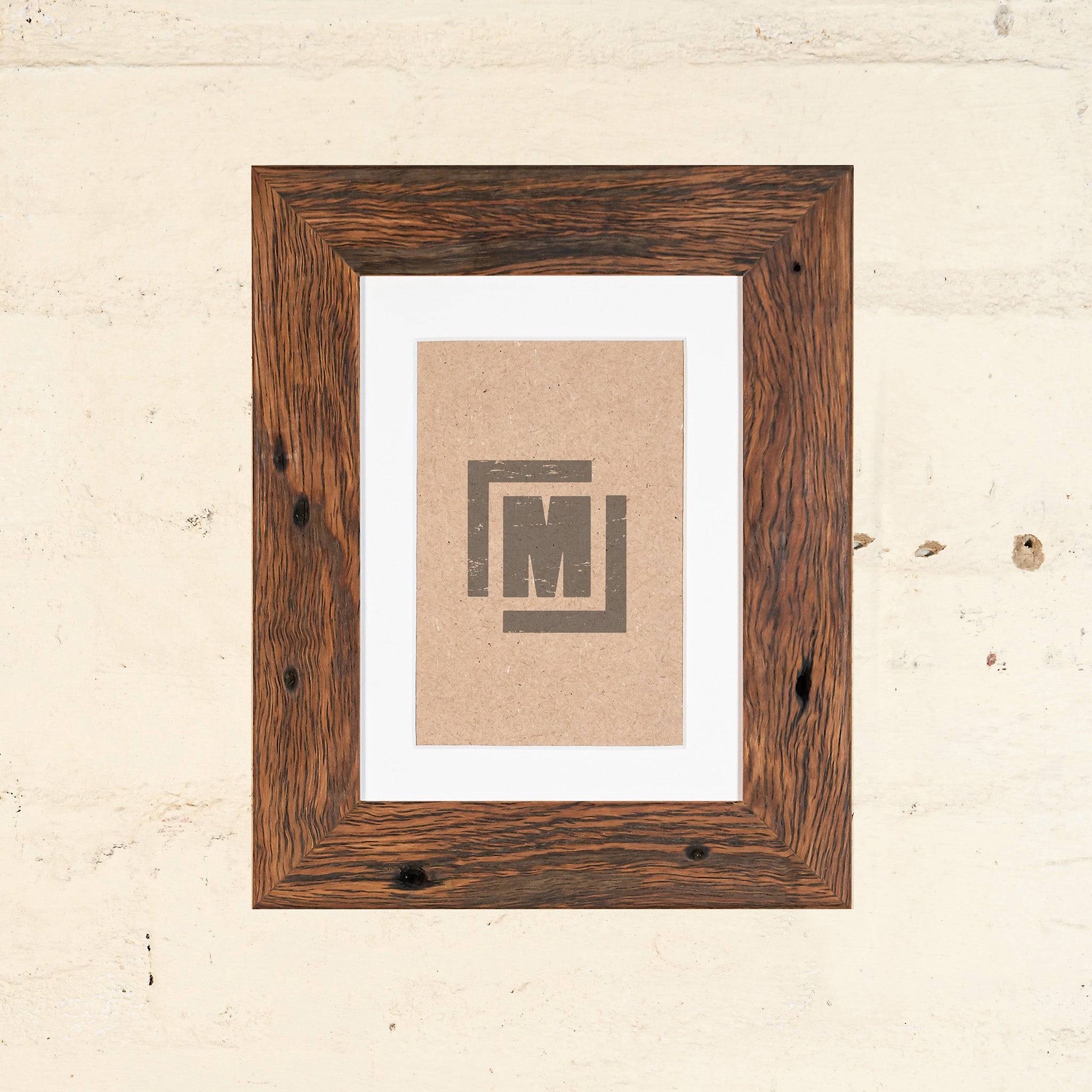 custom made photo frames. Medium brown photo frame, side on photo. Thin timber frame. 