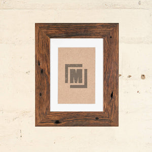 custom made photo frames. Medium brown photo frame, side on photo. Thin timber frame. 