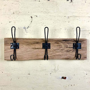 Wallnut coloured timber driftwood  coat rack with brown hooks. Solid, string, tough wooden coat rack Australia. 