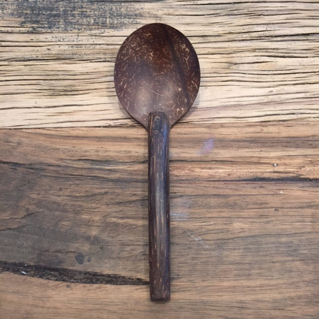 Dark brown wooden spoon made from coconut shells and kithul wood. Smooth finish, sustainably sourced. 
