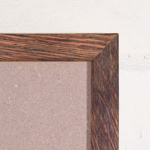 Close up of corner of thin, rustic timber photo frame. 