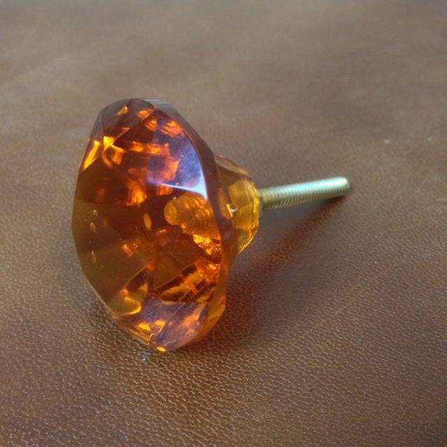 Amber orange coloured drawer handles. 