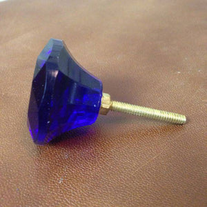 Side on shot of long glass cupboard handle, dark blue or navu colour. 