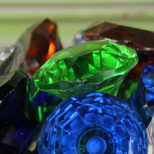 Close up of various colour cupboard handles and knobs. 