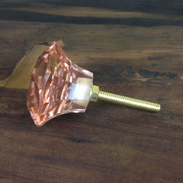 Light orange peach coloured drawer handles for bedroom cupboard. 