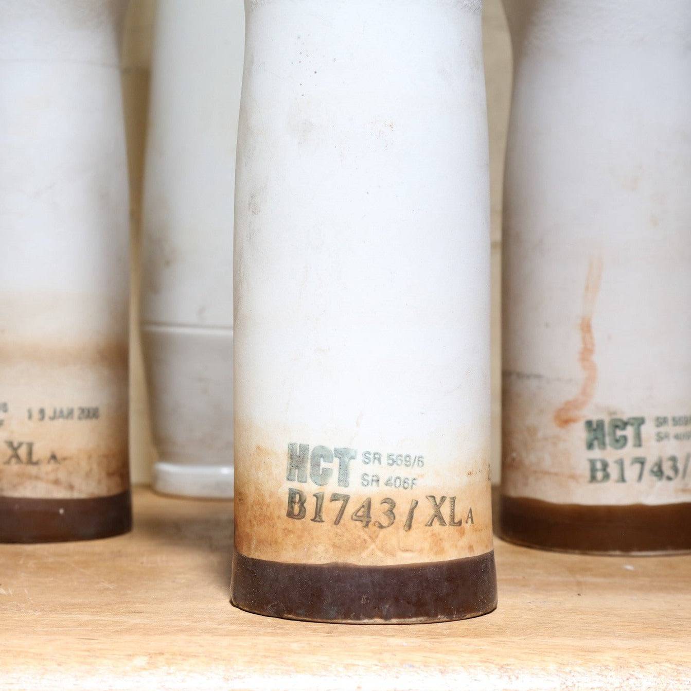 Close up of base of vintage white glove moulds. 