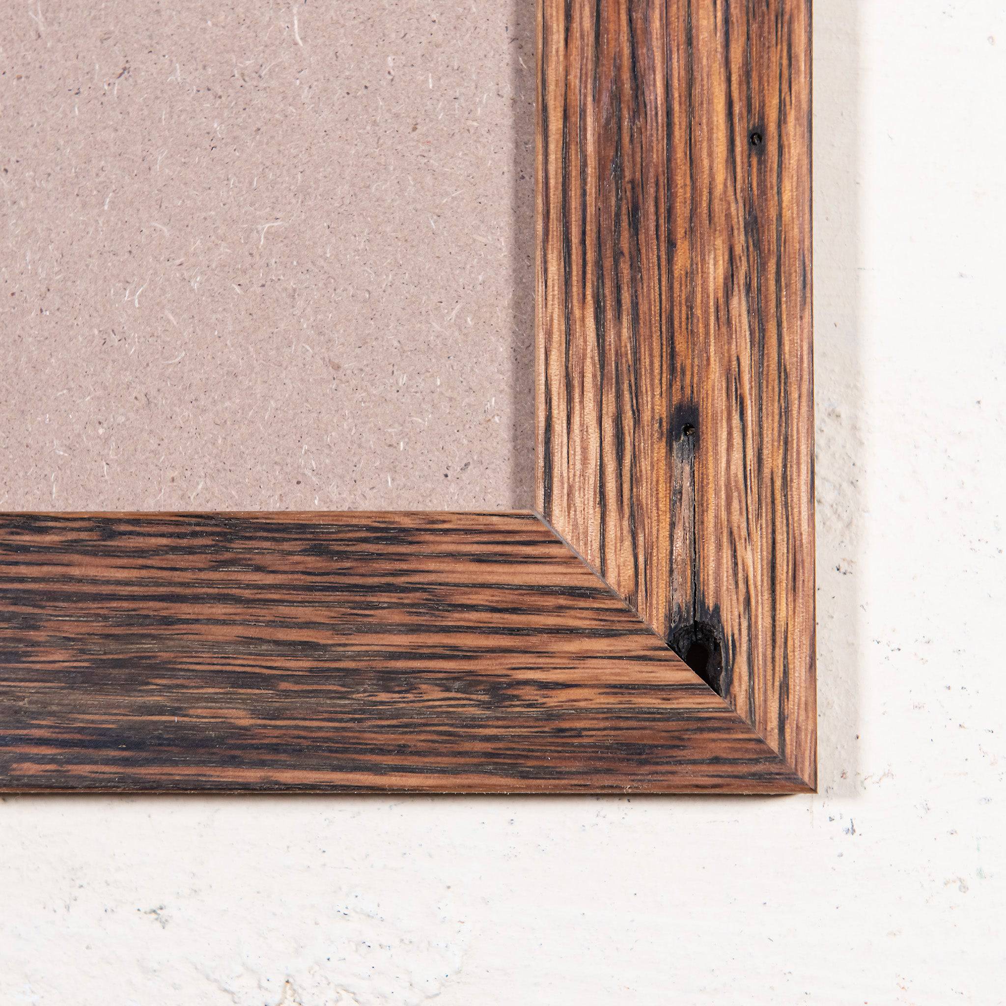 custom picture frames online. Close up of corner of picture frame, recycled wood, honey brown colour. 