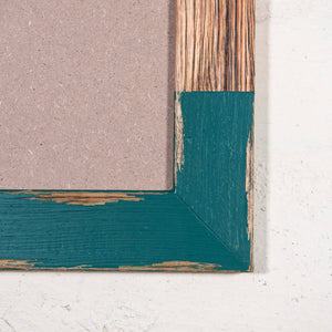 Close up photo of timber and green painted photo frame by Mulbury. The best place to frame pictures