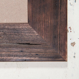 Close up of thick, wide wooden picture frame corner, dark brown colour. 
