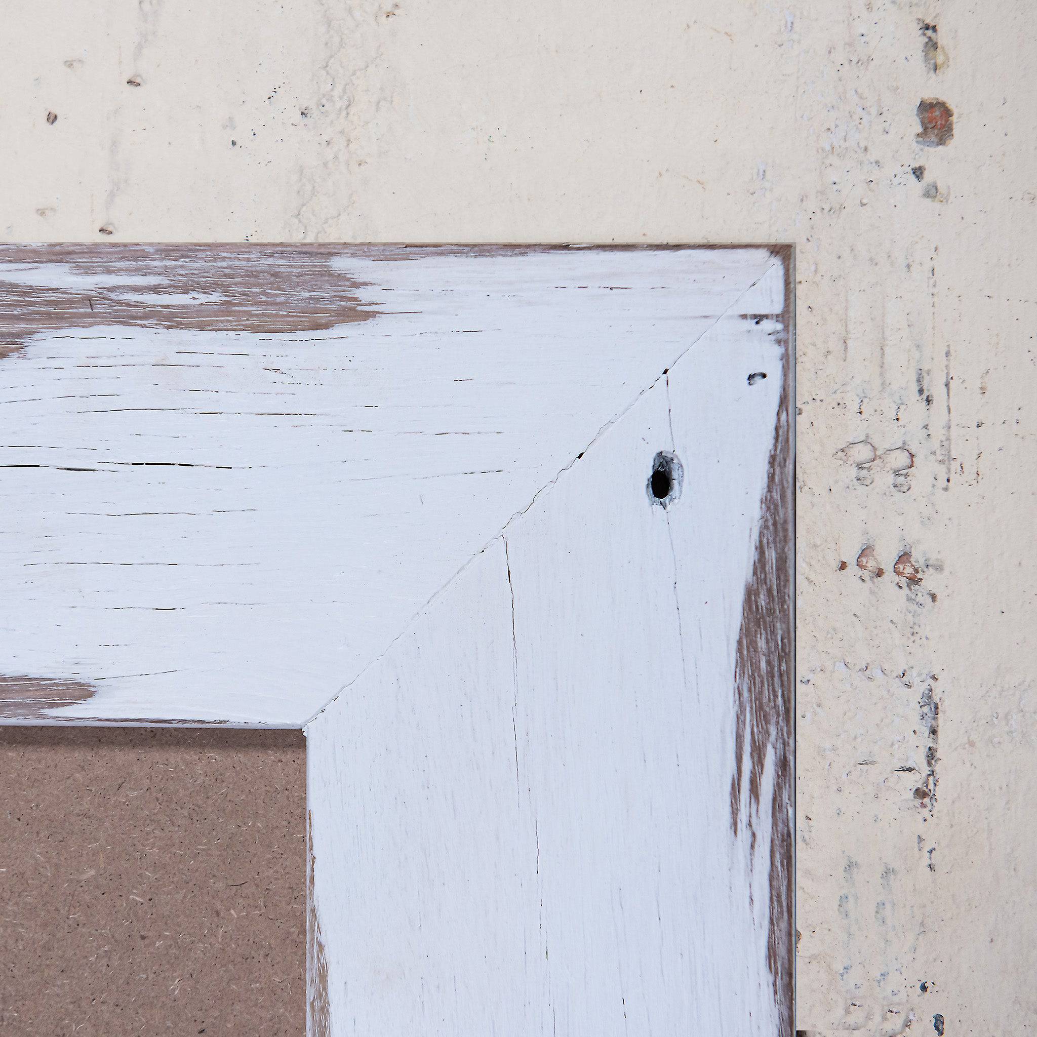 Close up of corner of white wood picture frame, weatherboard photo frames. 